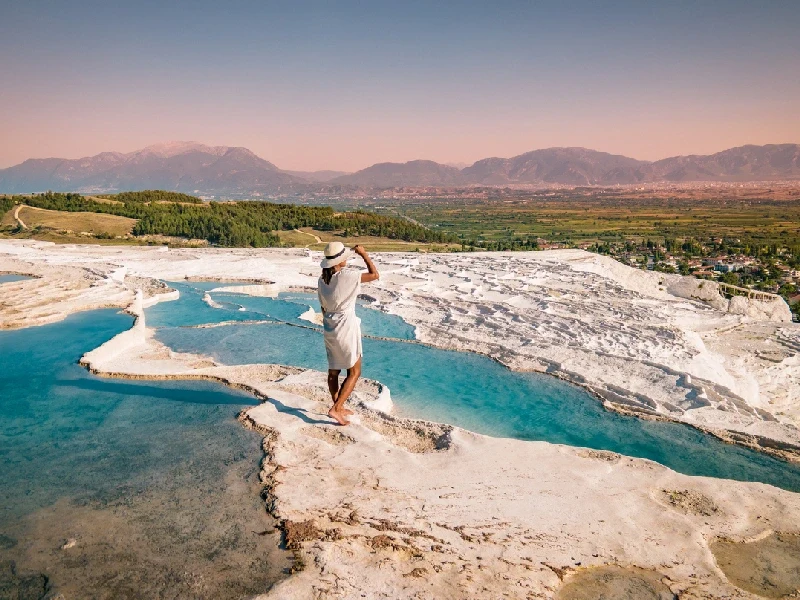 Scenic view of Pamukkale with a woman in white dress