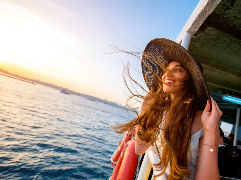 Tourist enjoying Bosphorus ferry ride in Istanbul, Summer in Turkey.