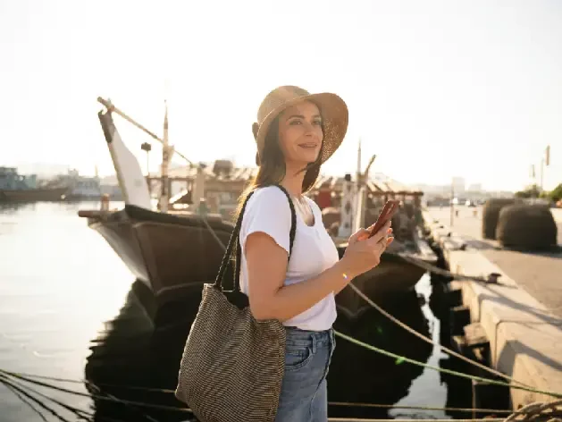 Female tourist by traditional dhows in Deira.