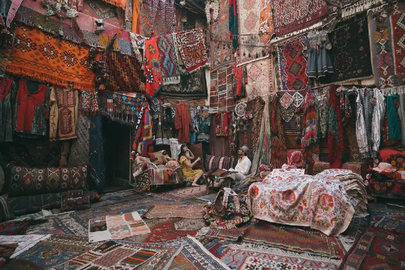 A vibrant Turkish carpet shop filled with colorful, traditional rugs and textiles.