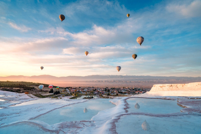 Hot air balloons in travertine pools in Pamukkale Hot air balloons in travertine pools in Pamukkale