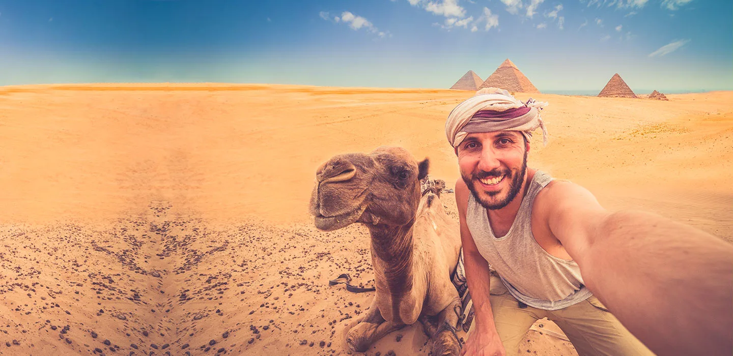 A happy traveller in front of Giza Pyramids