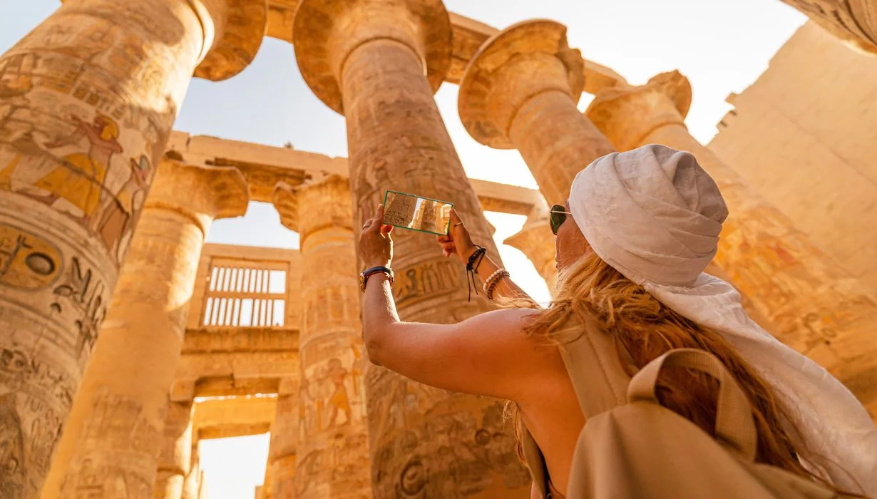 a tourist walks between pillars of the great hypostyle hall, Cairo Luxor tour