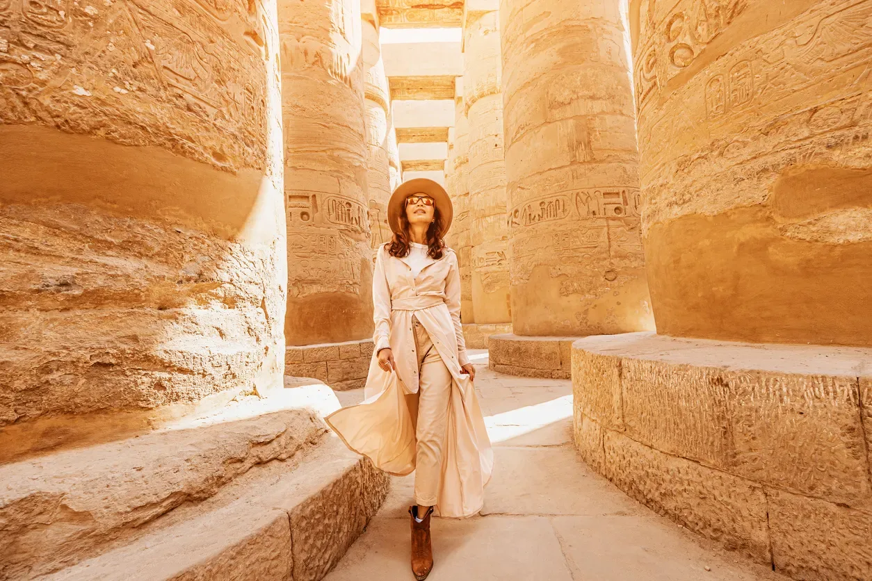 a traveller explores the ruins of the ancient karnak temple, Cairo Luxor tour