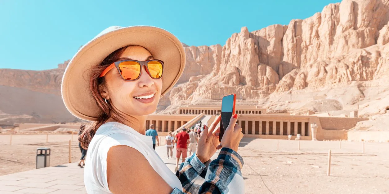 a girl takes pictures at the temple of hatshepsut, Trip to Egypt in December