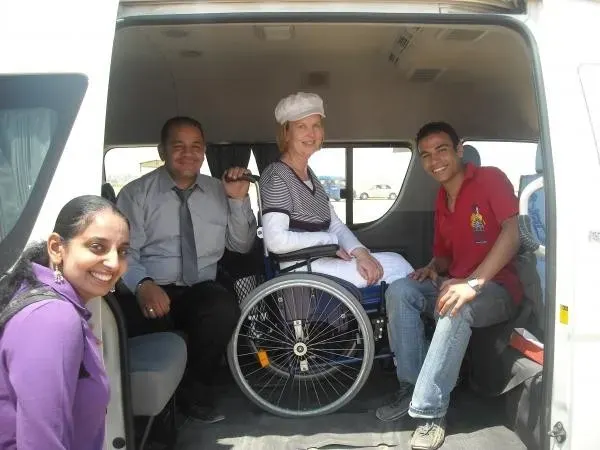 a woman with wheelchair in a bus with helpers, Accessible Alexandria Abu Simbel Tour