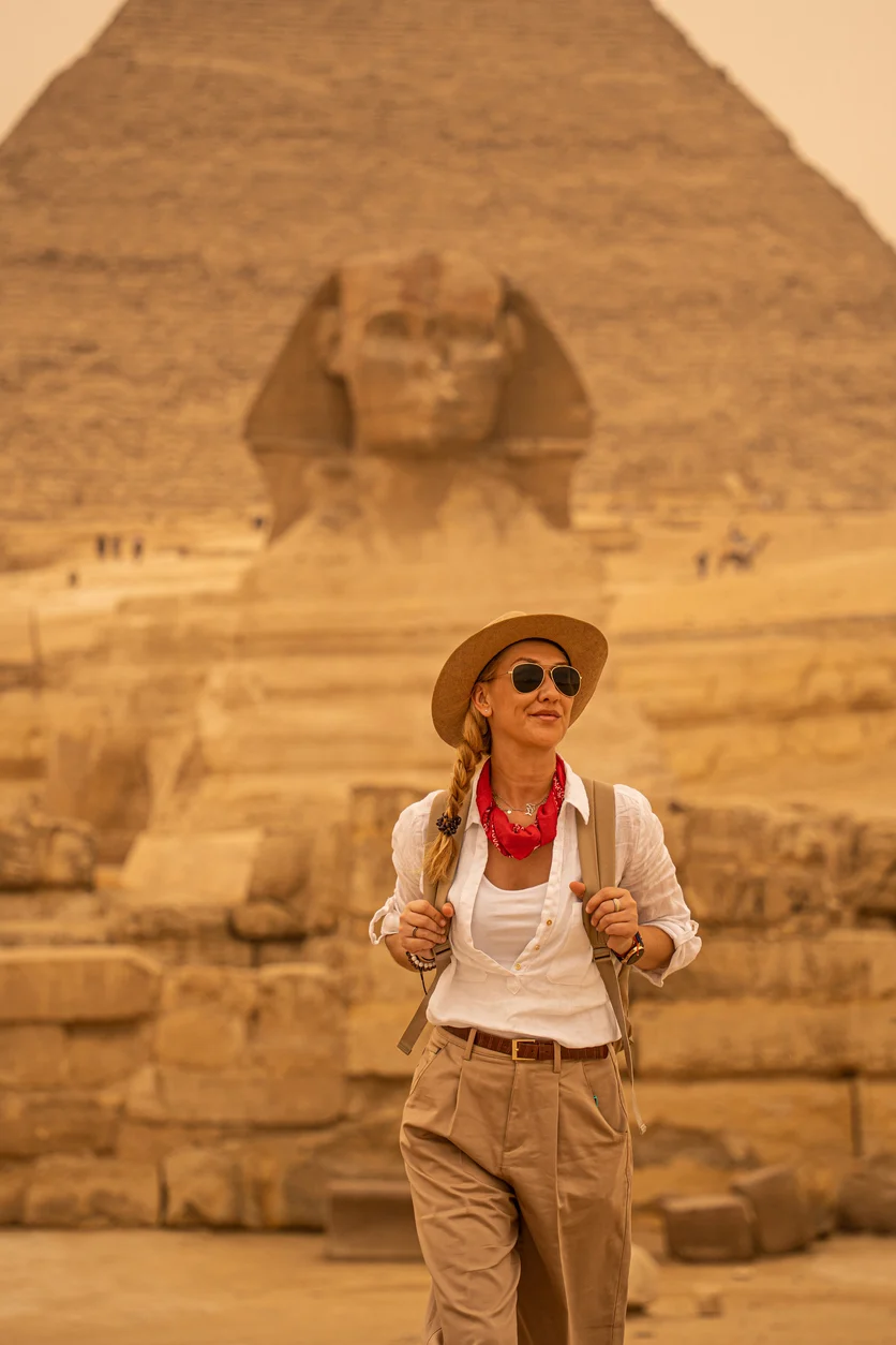 Woman standing in front of the background of Giza pyramids and Sphinx, Alexandria Shore Excursions
