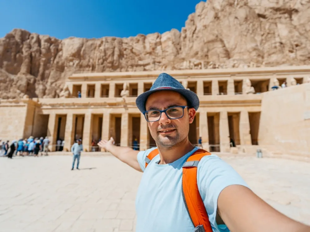 Mid-adult man taking selfies at The Mortuary Temple Of Hatshepsut in Luxor in Egypt.