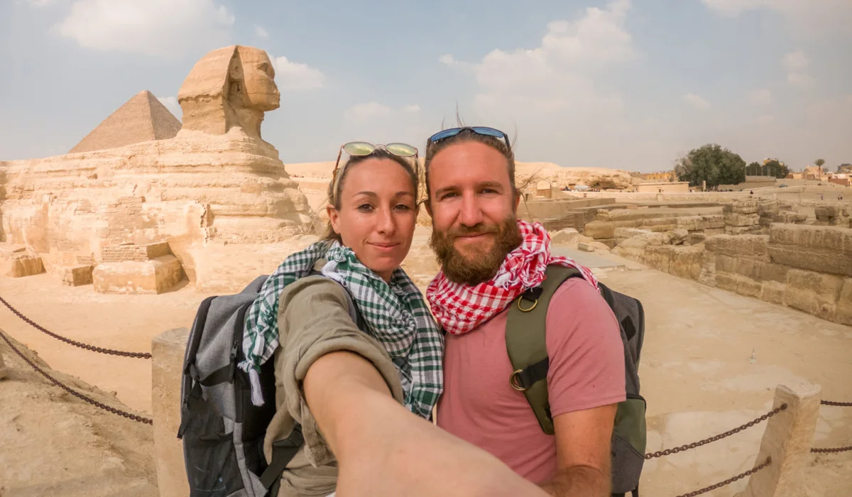 couple takes selfie in front of the Sphinx, Tour Guide to Egypt