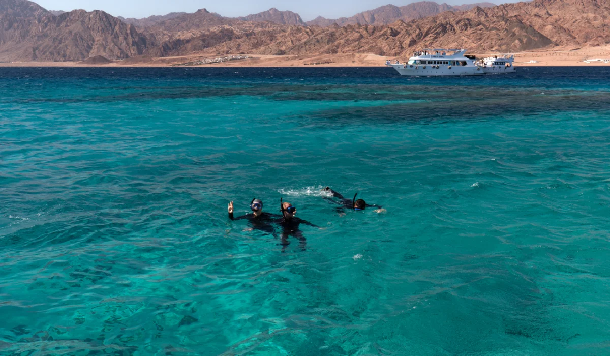 three people snorkel in the red sea, Best Snorkeling Sites in Red Sea