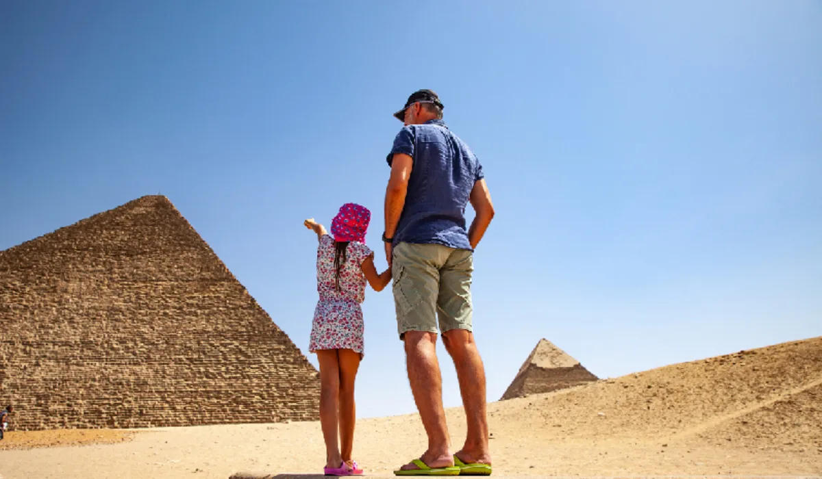 Father and Daughter Looking at Kheops Pyramid in Giza