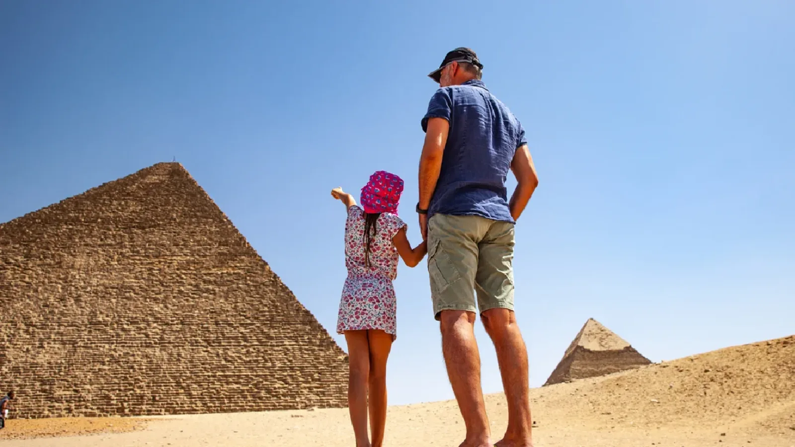 Father and Daughter Looking at Pyramids in Giza.