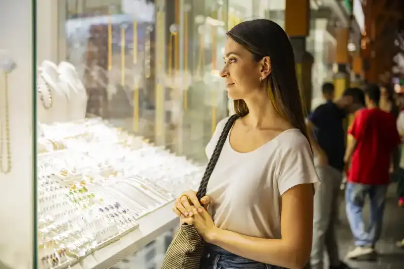 Donna che fa shopping in vetrina al Dubai Gold Souk, mercato dell'oro di Dubai