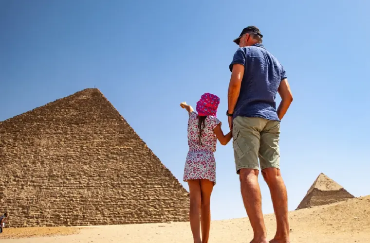 Father and Daughter Looking at Pyramids in Giza.