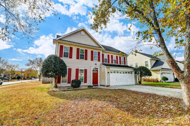 Large house with a garage and driveway | Real estate listings