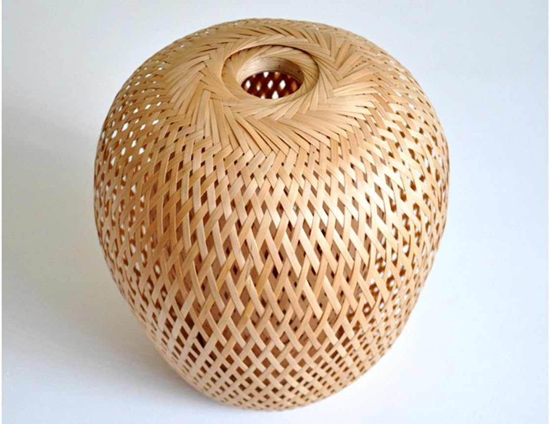 Petra Openwork Bamboo Pendant — hanging over a dining table