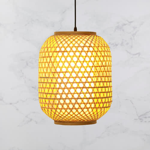 Handwoven Bamboo Bell Pendant — hanging over a dining table