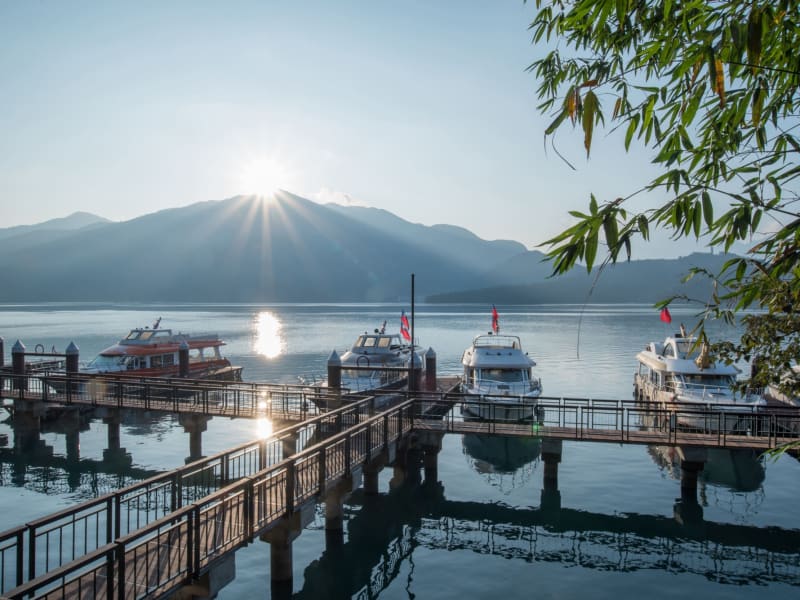 Morning tranquility at Sun Moon Lake - where mountains meet crystal waters and wooden piers frame Taiwan's most iconic alpine lake.