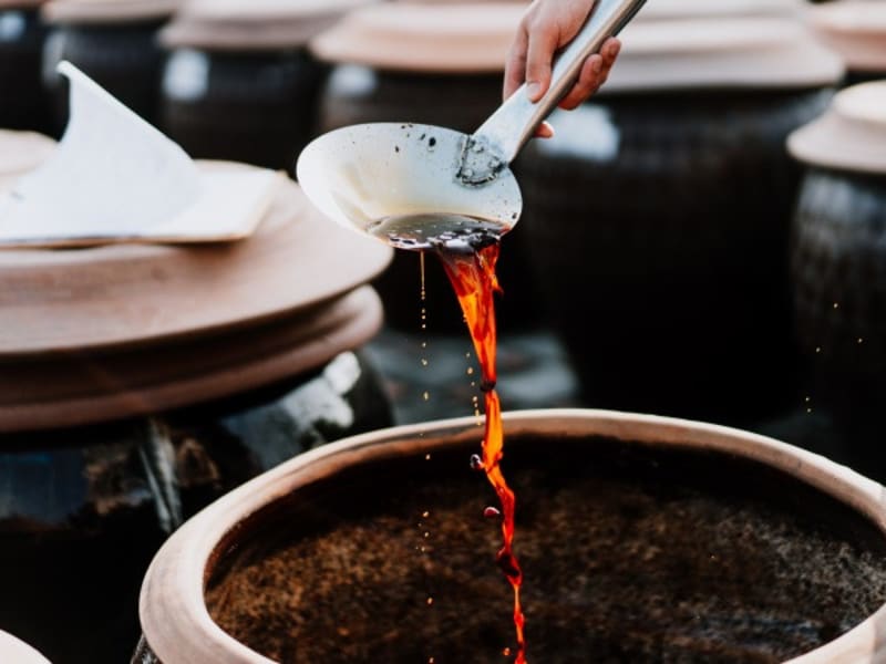 Discover the ancient art of soy sauce fermentation, where time, sun, and massive ceramic urns slowly transform simple ingredients into deep, complex flavors.