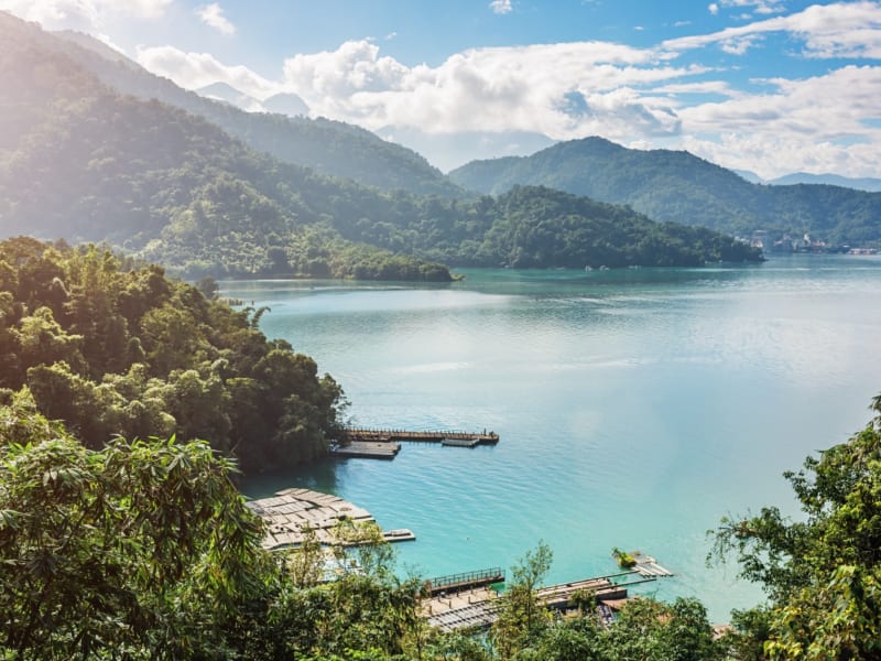 Sun Moon Lake on a clear morning — still water, forested hills, and the unhurried feeling that this place was made for.