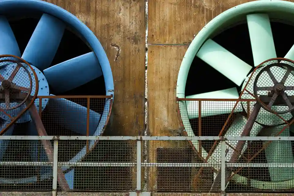 Close-up view of two large industrial ventilation fans mounted
