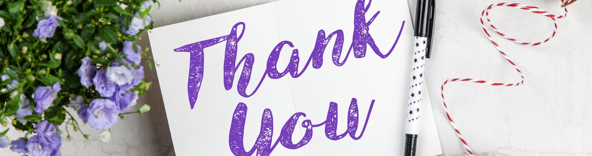 a thank you note with purple flowers