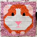 Woollypetals It's All Guinea Be Okay quilt block with red polka dot guinea pig face