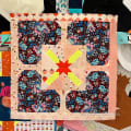 Woollypetals Hearts All Around Quilt with X Star center block in colorful floral fabrics