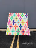 Woollypetals Moonrise quilt with colorful plus sign blocks on cream background