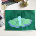 Woollypetals Moth Eclipse FPP pattern with green, lime, and purple fabric wings