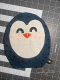 Woollypetals Penguin Pillow with cream face, red beak, and dark blue star-patterned body
