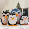 Woollypetals Penguin Pillow in multiple sizes displayed together