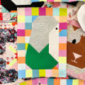 Woollypetals Penguin Social quilt block with colorful patchwork border