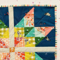 Woollypetals Starfy Mini quilt with colorful sawtooth star design