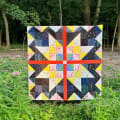 Woollypetals Starfy quilt with bold star blocks in multicolored fabrics