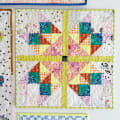 Woollypetals Starfy quilt with colorful star blocks and lime green border