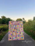 Woollypetals Stargeese Quilt displayed on rural gravel path