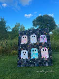 Woollypetals Ghost Party quilt displayed outdoors with colorful ghost blocks