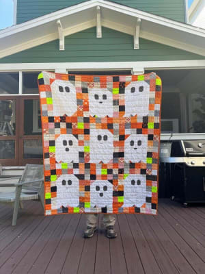 Woollypetals Ghost Party quilt with white ghost blocks on colorful patchwork background