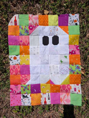 Woollypetals Ghost Party quilt with colorful fabric blocks and white ghost squares