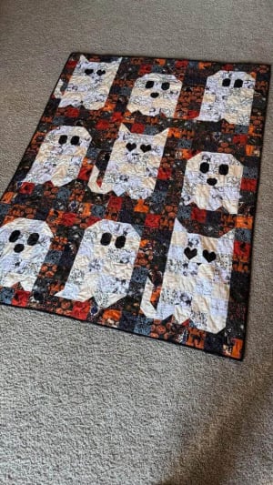 Woollypetals Ghost Party quilt with white ghost blocks on colorful fabric
