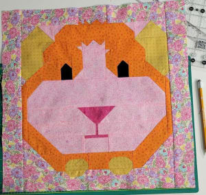 Woollypetals It's All Guinea Be Okay quilt block with orange and pink fabric