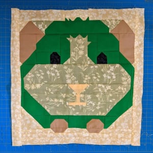 Woollypetals It's All Guinea Be Okay quilt block in green and tan fabrics