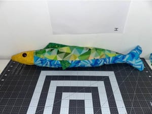 Woollypetals Sardine Pillow in yellow, green, and blue patterned fabrics