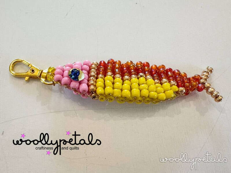 Woollypetals Beaded Sardine Charm with pink, yellow, orange and red beads