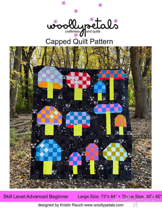 Woollypetals Capped quilt with colorful patchwork mushroom blocks on black background