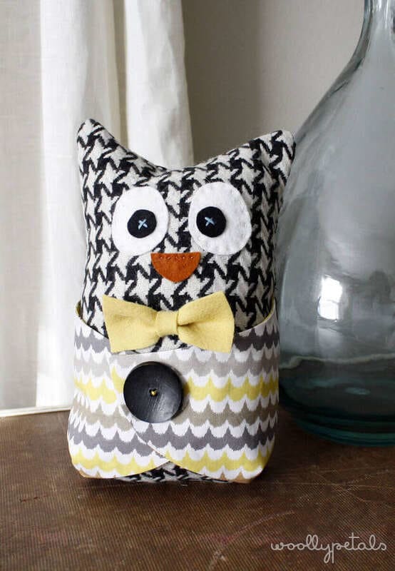 Handmade fabric owl with patterned body, yellow bow tie, and button details
