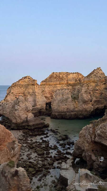 Algarve coastal rock formations with turquoise water and beach cove