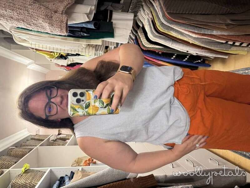 Person holding phone with yellow floral phone case in craft room