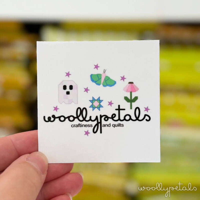 Woollypetals logo label with ghost, butterfly, flower, and star designs
